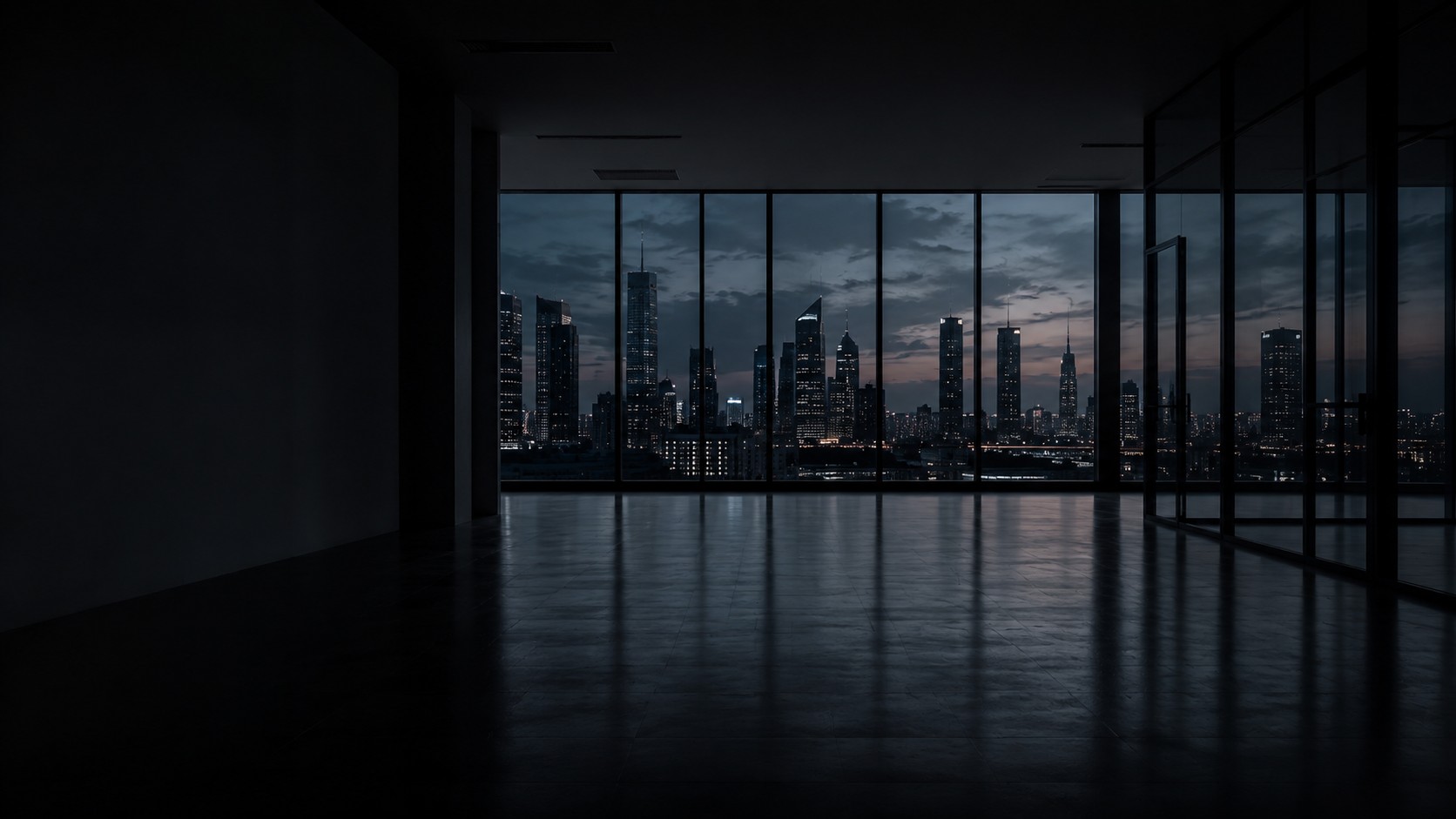 Quiet office interior at dusk overlooking a city skyline through a window wall
